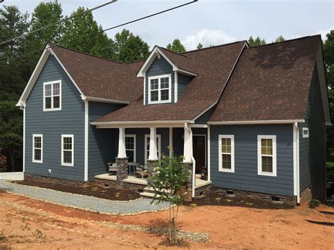 brown metal roof blue house|exterior paint for brown roof.